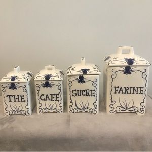 Set of four unique white square canisters with Blue French Letters.